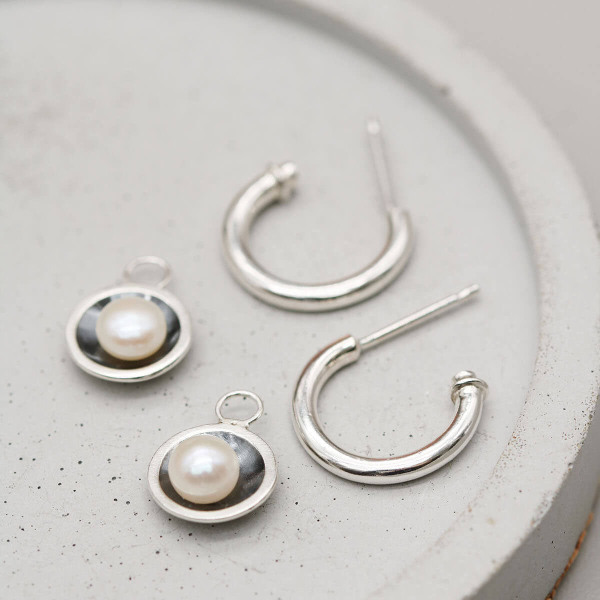 Contemporary black pearl hoop earrings inspired by Art Deco design with oxidised sterling silver settings.