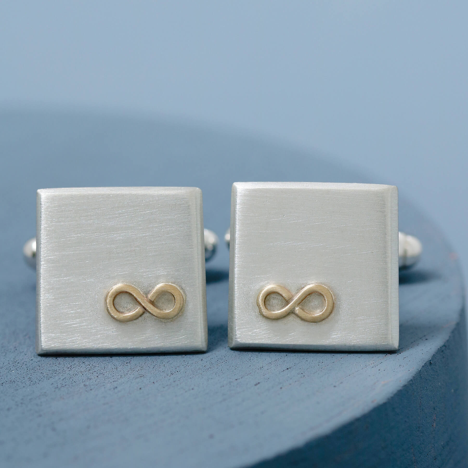 Both cufflinks front on, showcasing the contrast of sterling silver and 9ct gold – the perfect husband anniversary gift or groom accessory.