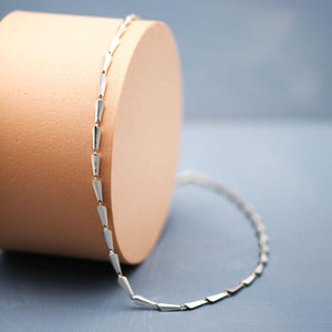 Contemporary silver link necklace with geometric Art Deco design, close-up product photograph