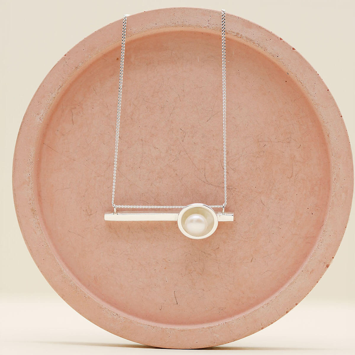 Sterling silver necklace with pearl pendant showcasing an Art Deco inspired horizontal geometric design.