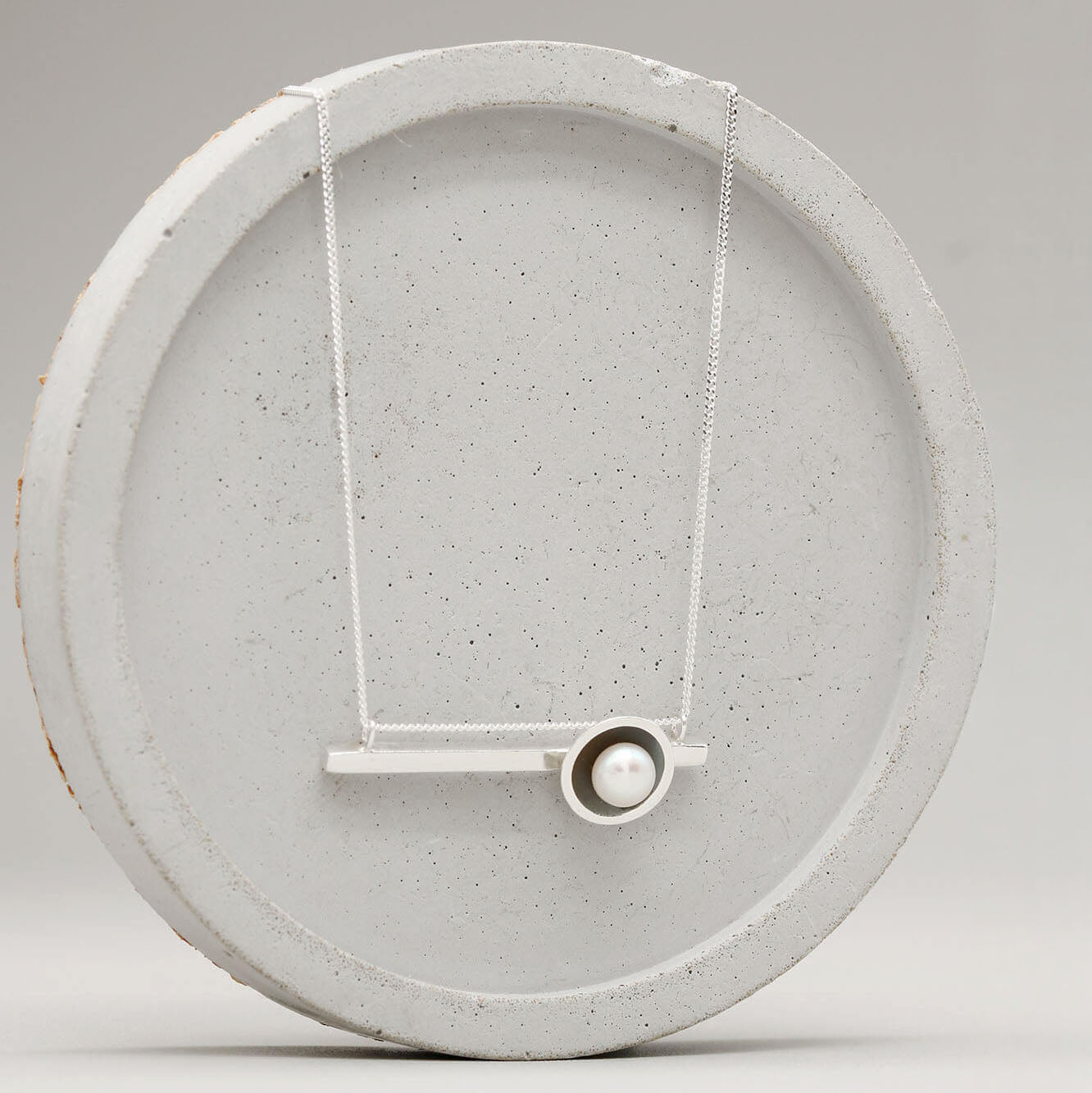 Handmade oxidised sterling silver pearl necklace showcasing a sleek horizontal design and genuine freshwater pearl.