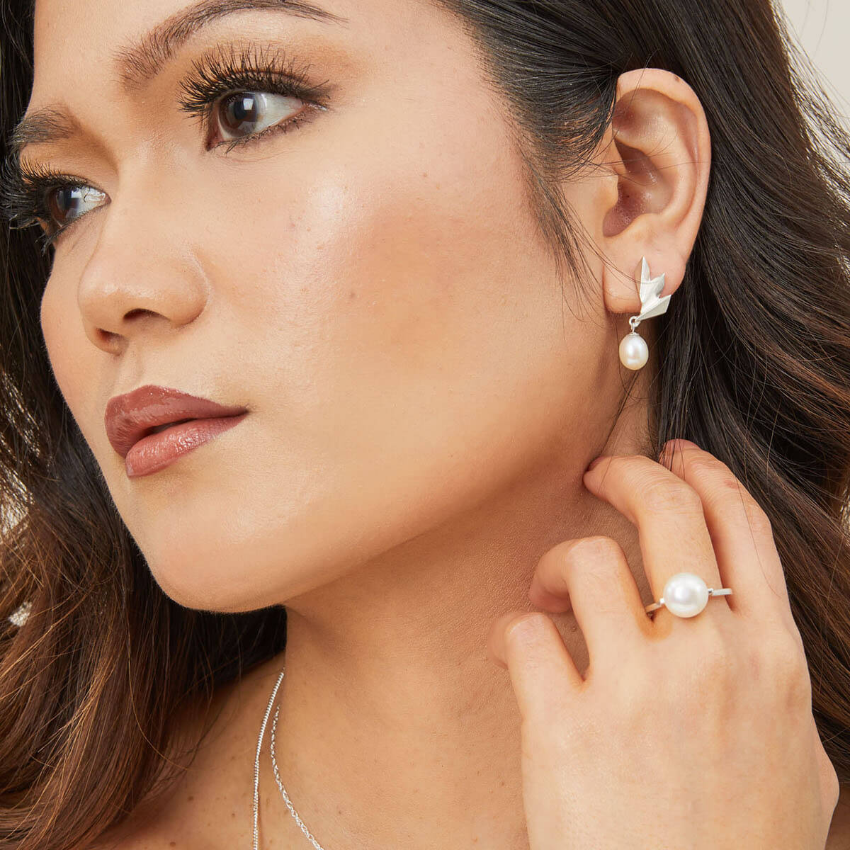 Model wearing a handmade large pearl ring with ivory white freshwater pearl