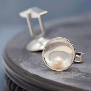 Sterling silver pearl cufflinks featuring freshwater pearls and an Art Deco inspired geometric design.