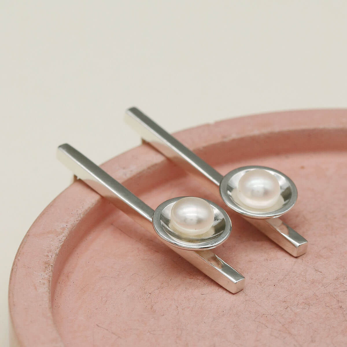 Handmade sterling silver pearl pendant earrings with elongated bar design and genuine freshwater pearls.