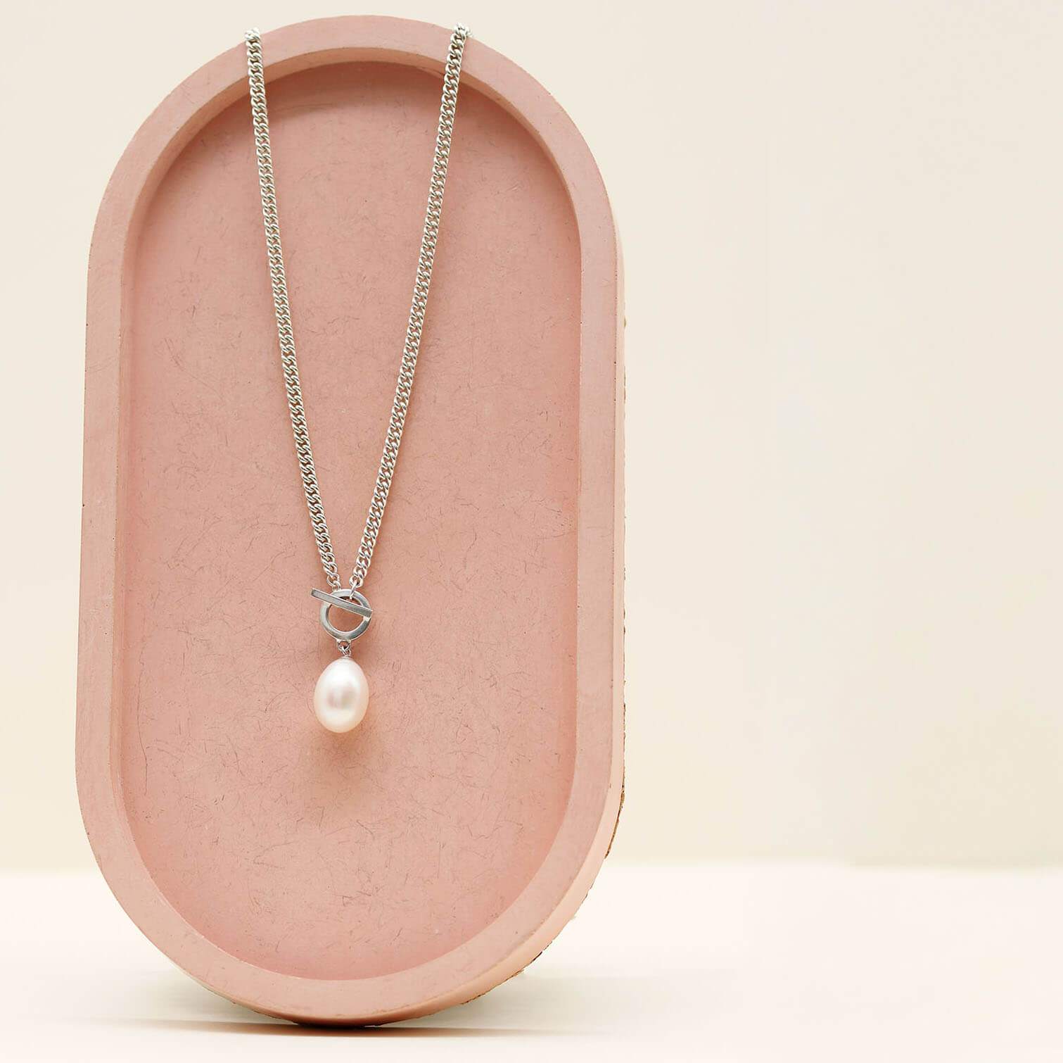 Handmade sterling silver necklace with a large freshwater pearl suspended from a contemporary toggle clasp.