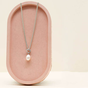 Handmade sterling silver necklace with a large freshwater pearl suspended from a contemporary toggle clasp.