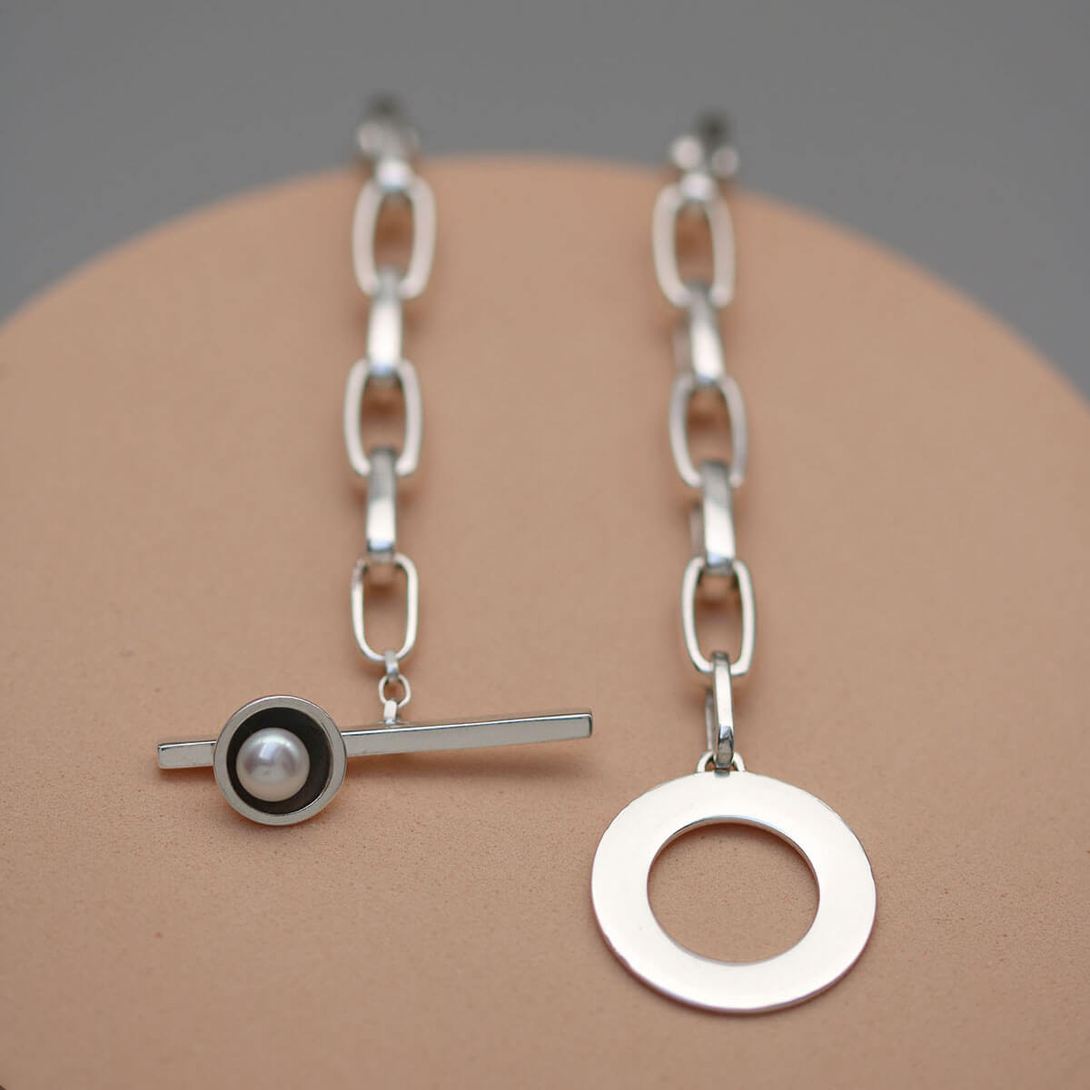 Handmade chunky pearl necklace in solid sterling silver highlighting the bold chain, oxidised pearl setting and freshwater pearl.