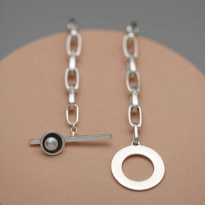 Handmade chunky pearl necklace in solid sterling silver highlighting the bold chain, oxidised pearl setting and freshwater pearl.