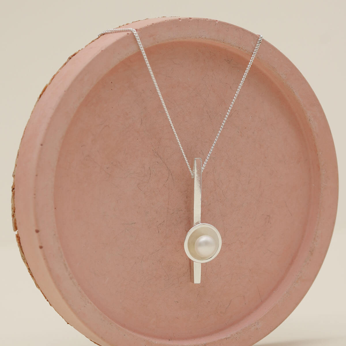 Close up of a pearl wedding necklace handcrafted in solid sterling silver with a genuine freshwater pearl.