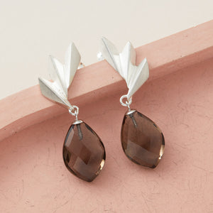 Detailed shot of art deco statement earrings with smoky quartz drops catching the light; ideal luxury gift for Christmas or milestone celebrations.