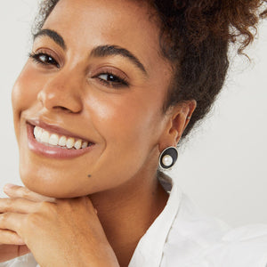 Contemporary oxidised silver pearl earrings worn by model