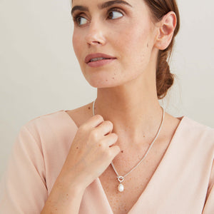 Sterling silver toggle pearl necklace worn at the neckline, featuring a genuine freshwater pearl and contemporary front fastening.