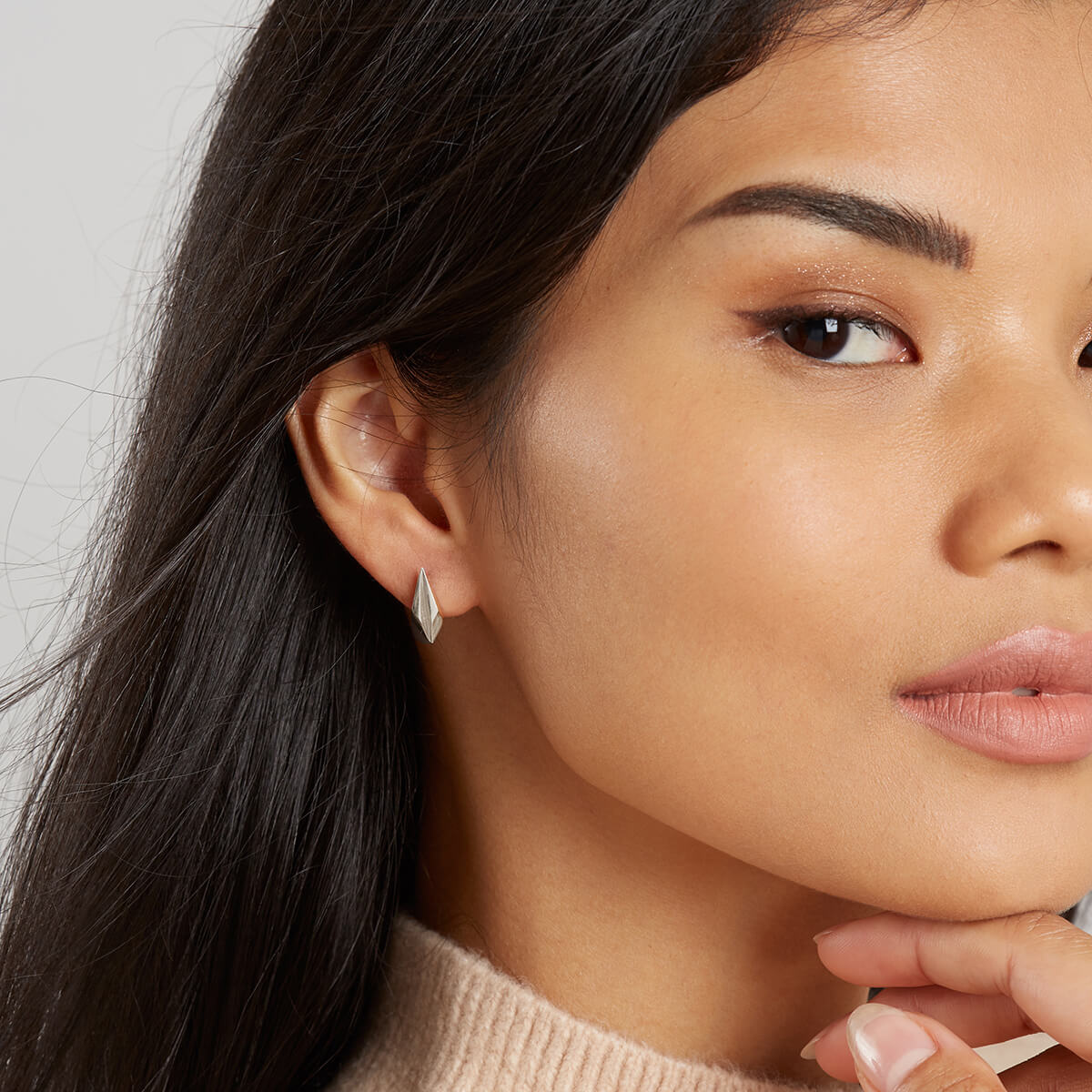 Model wearing silver art deco earrings as a gift for bridesmaids, birthdays, or anniversaries.