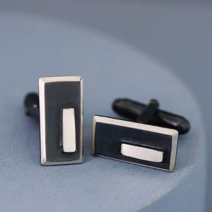 One cufflink face front on and the other angled to show depth and shine, beautifully presented on a deep blue background — ideal special gift for husband’s birthday.