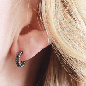 Small black hoop earrings worn in the ear, black hoop earrings for women styled for everyday wear