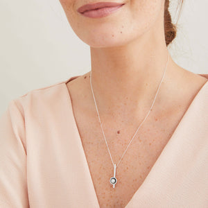 Black pearl bar necklace worn with a white blouse, showing the elegant horizontal bar pendant on an 18 inch chain.