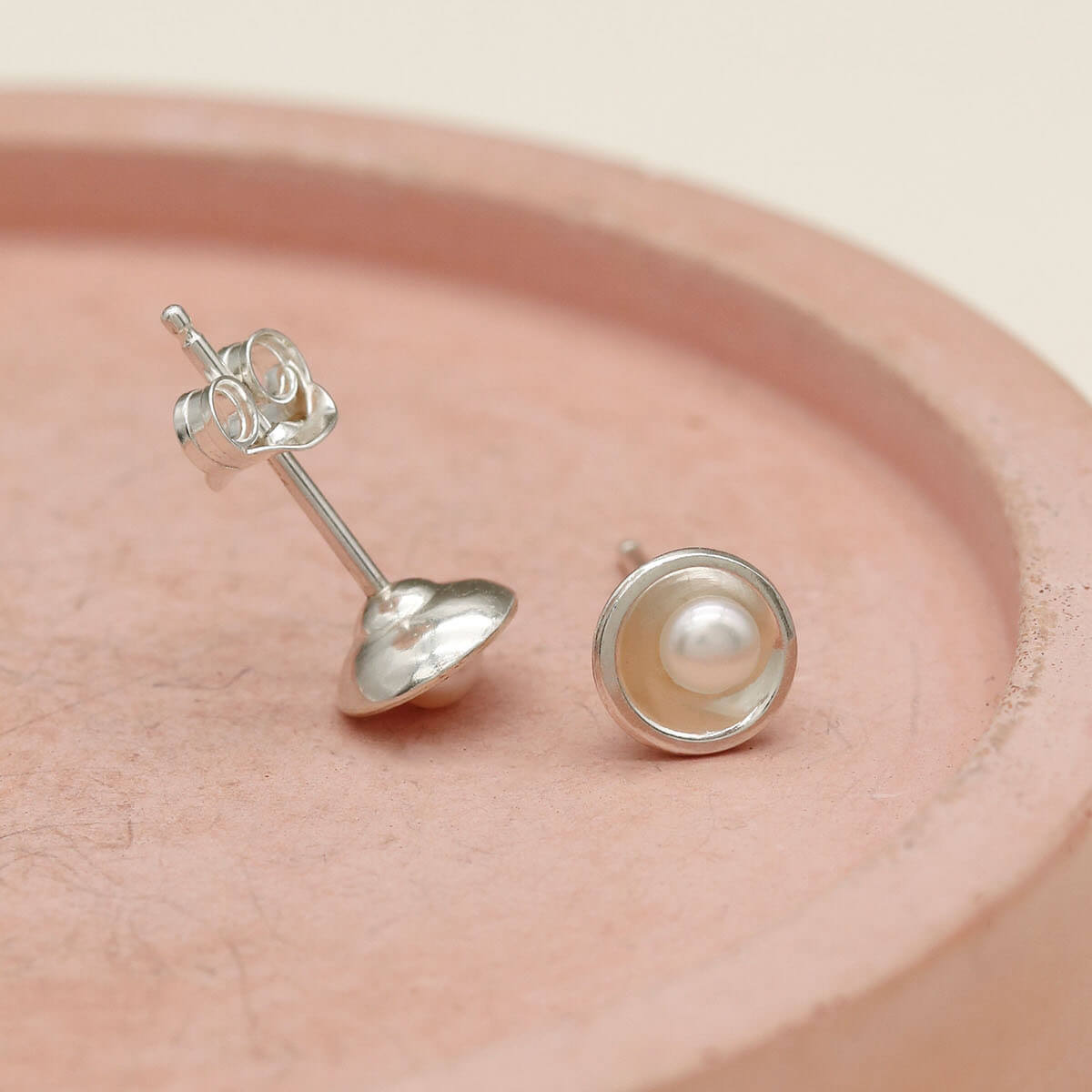 Small pearl stud earrings handcrafted from sterling silver with freshwater pearls