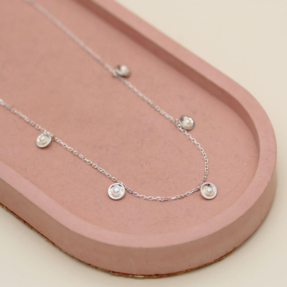 Handmade sterling silver pearl chain necklace highlighting five petite freshwater pearls in an elegant Art Deco inspired design.