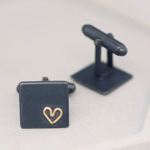 Pair of silver cufflinks with gold heart detail on grey dish, meaningful Groom wedding cufflinks for the groom or husband.