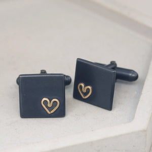 Silver cufflinks with gold heart detail on grey dish, classic special anniversary gifts for husband, free delivery included.