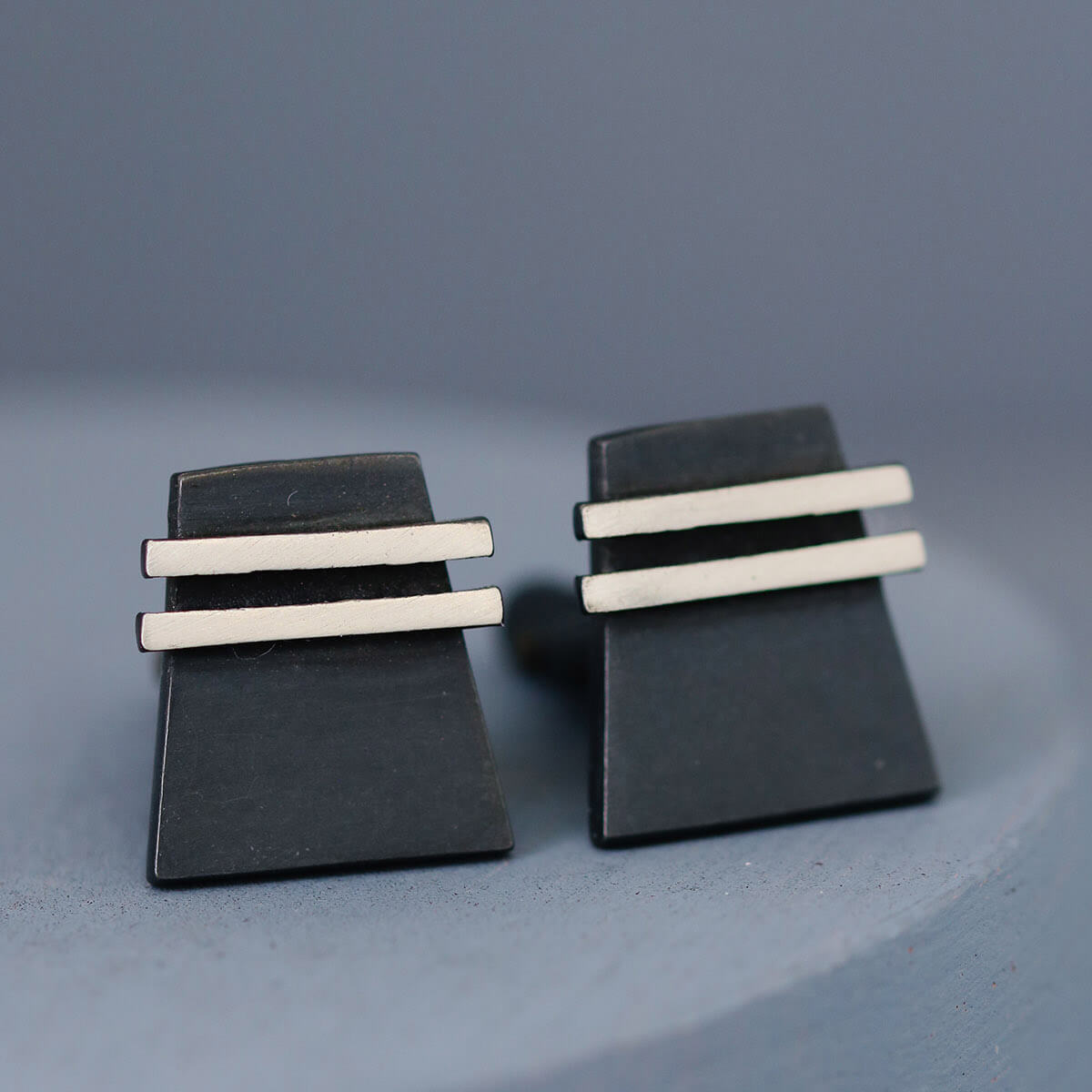 Up-close detail of one black cufflink focusing on the oxidised finish. Great gift for husband or men who appreciate sleek modern design.