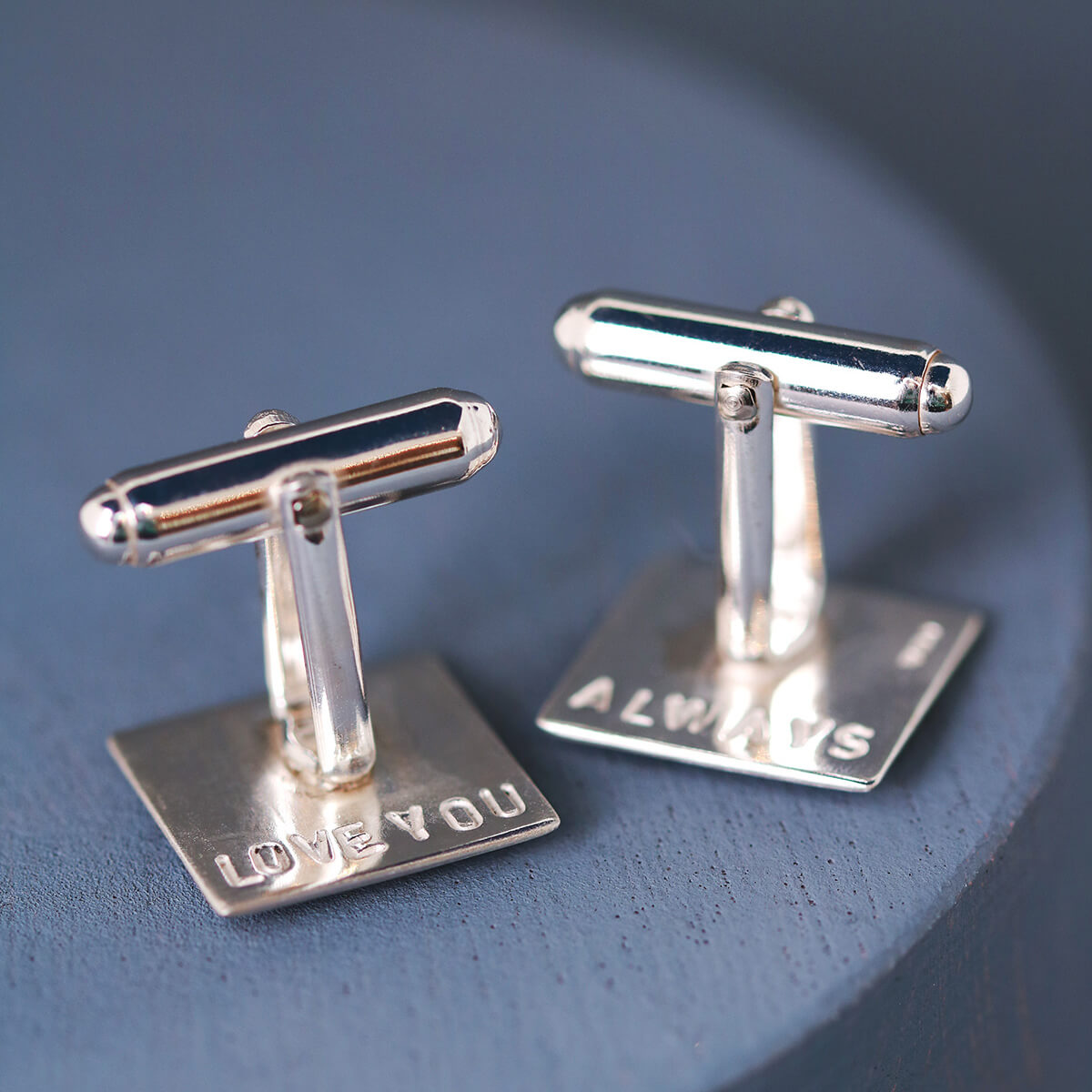 Personalised motorbike cufflinks on a deep blue background, meaningful gifts for a biker dad to wear on special occasions