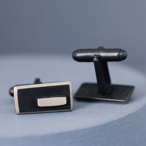Overhead image of both cufflinks positioned neatly on a deep blue surface, emphasising the minimalist Art Deco style.