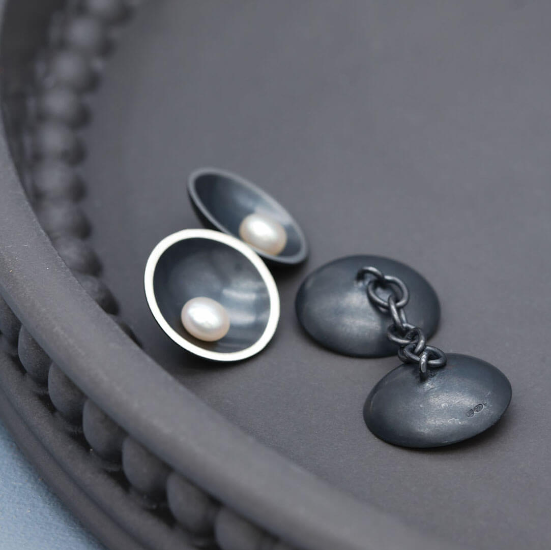 Handmade pearl cufflinks in oxidised sterling silver with chain-linked double-sided pearl detail.
