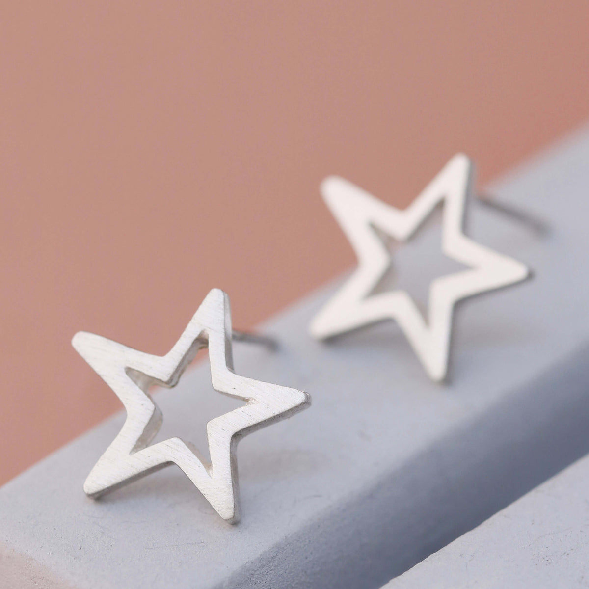 Star sterling silver earrings on grey dish, handmade good luck earrings for her