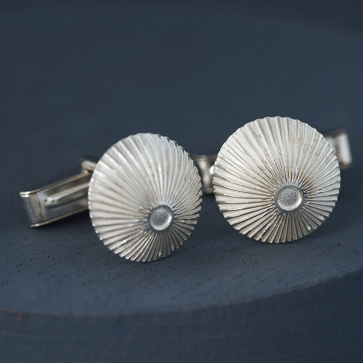 Pair of sterling silver cufflinks on deep blue with Art Deco engraving – ideal round cufflinks for best man or groomsmen gift.
