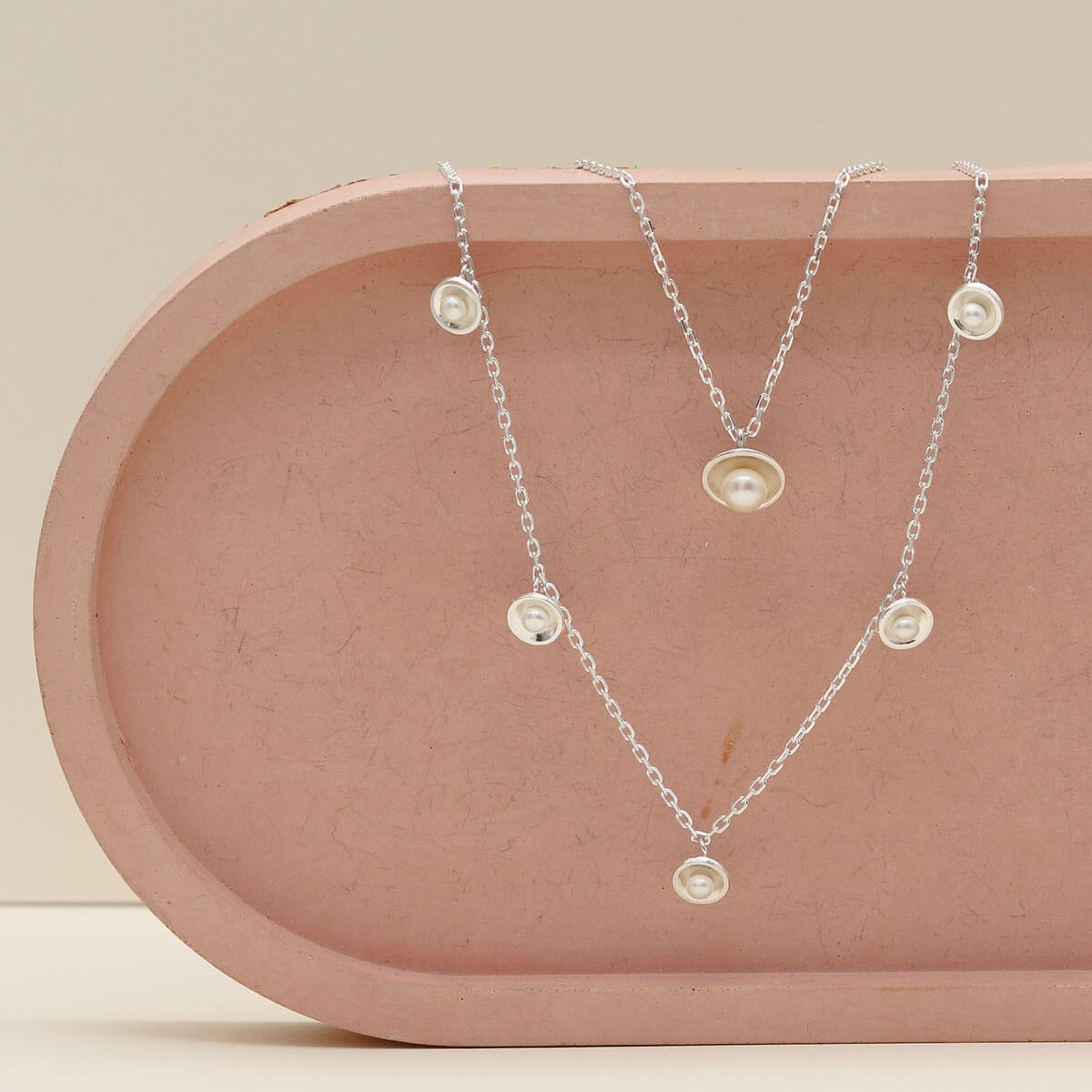 Sterling silver pearl chain necklace layered with the original sterling silver pearl pendant necklace, creating an elegant everyday layered necklace look.