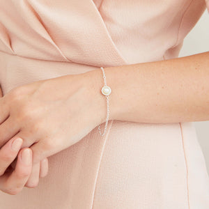 Delicate sterling silver pearl bracelet worn on its own, showcasing the timeless design and genuine freshwater pearl.
