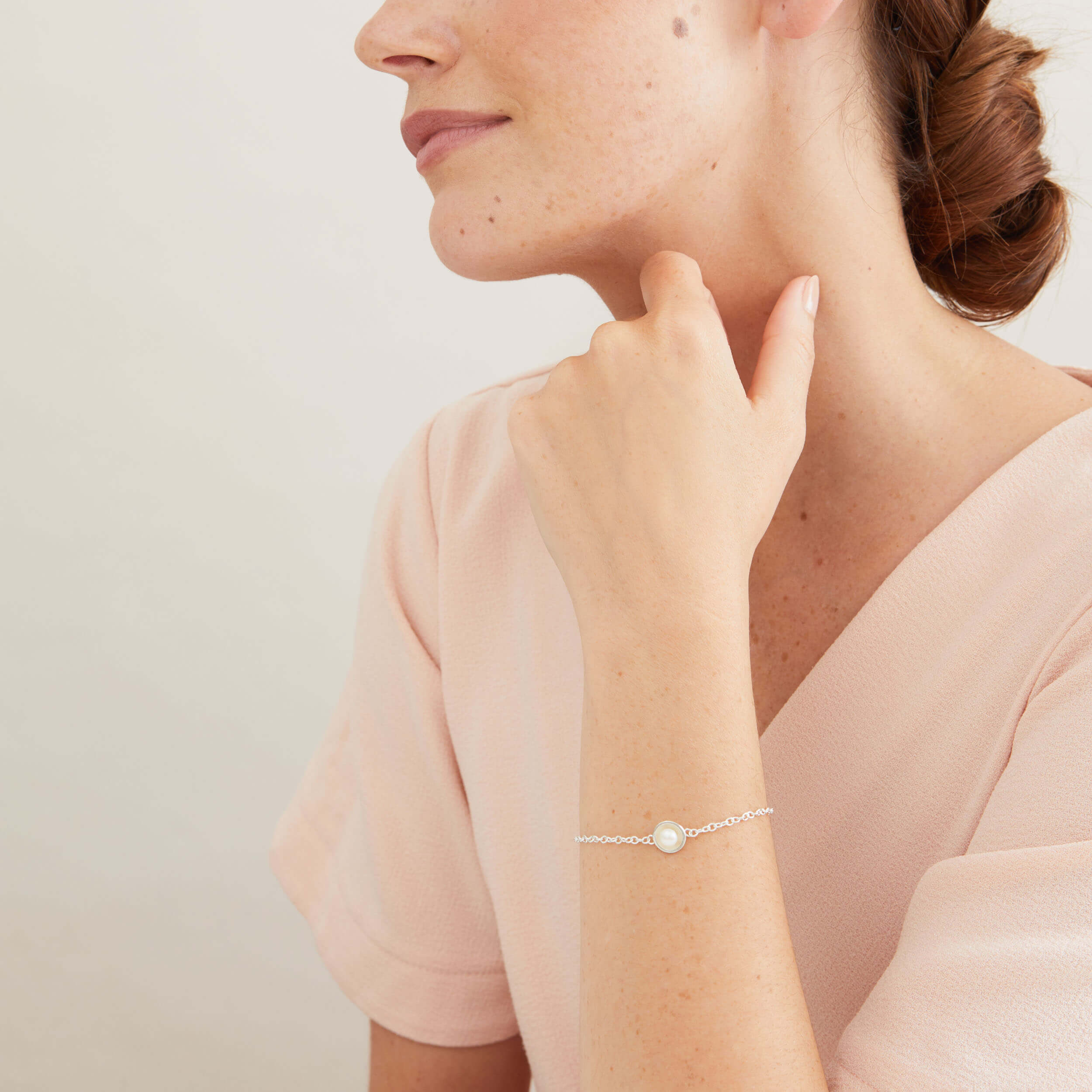 Sterling silver pearl bracelet worn on the wrist, showcasing the polished silver setting and genuine freshwater pearl.
