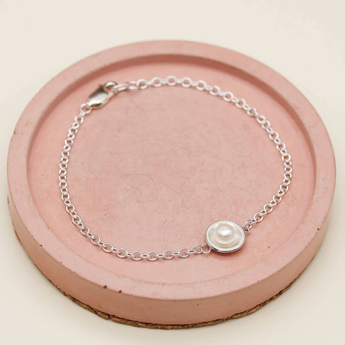 Sterling silver and pearl bracelet featuring a polished silver setting and delicate sterling silver chain.