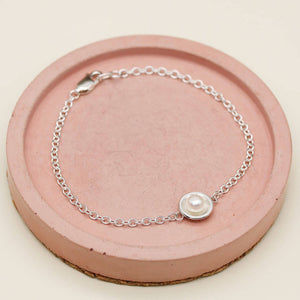 Sterling silver and pearl bracelet featuring a polished silver setting and delicate sterling silver chain.