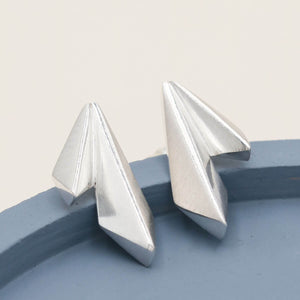 Geometric silver earrings with overlapping kite shapes, understated statement jewellery for everyday outfits