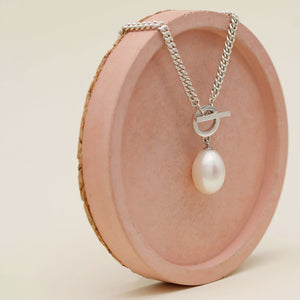 Handmade sterling silver necklace with front toggle fastening and a genuine freshwater pearl in an Art Deco inspired design.
