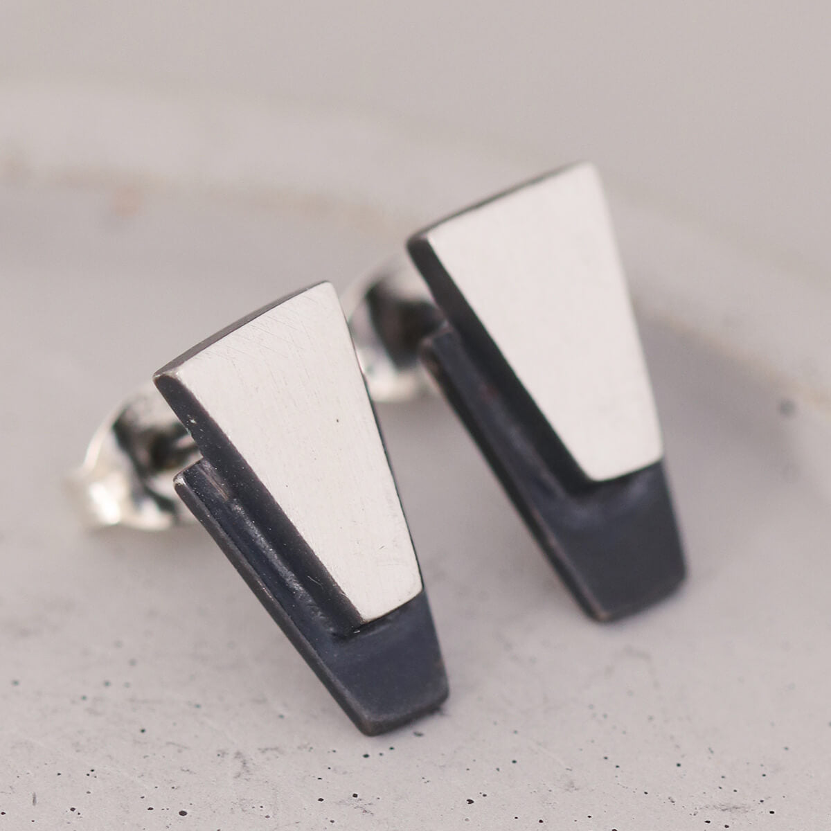 Sterling silver black earrings photographed on grey dish with clean modern lines, perfect Valentine’s Day or anniversary present.