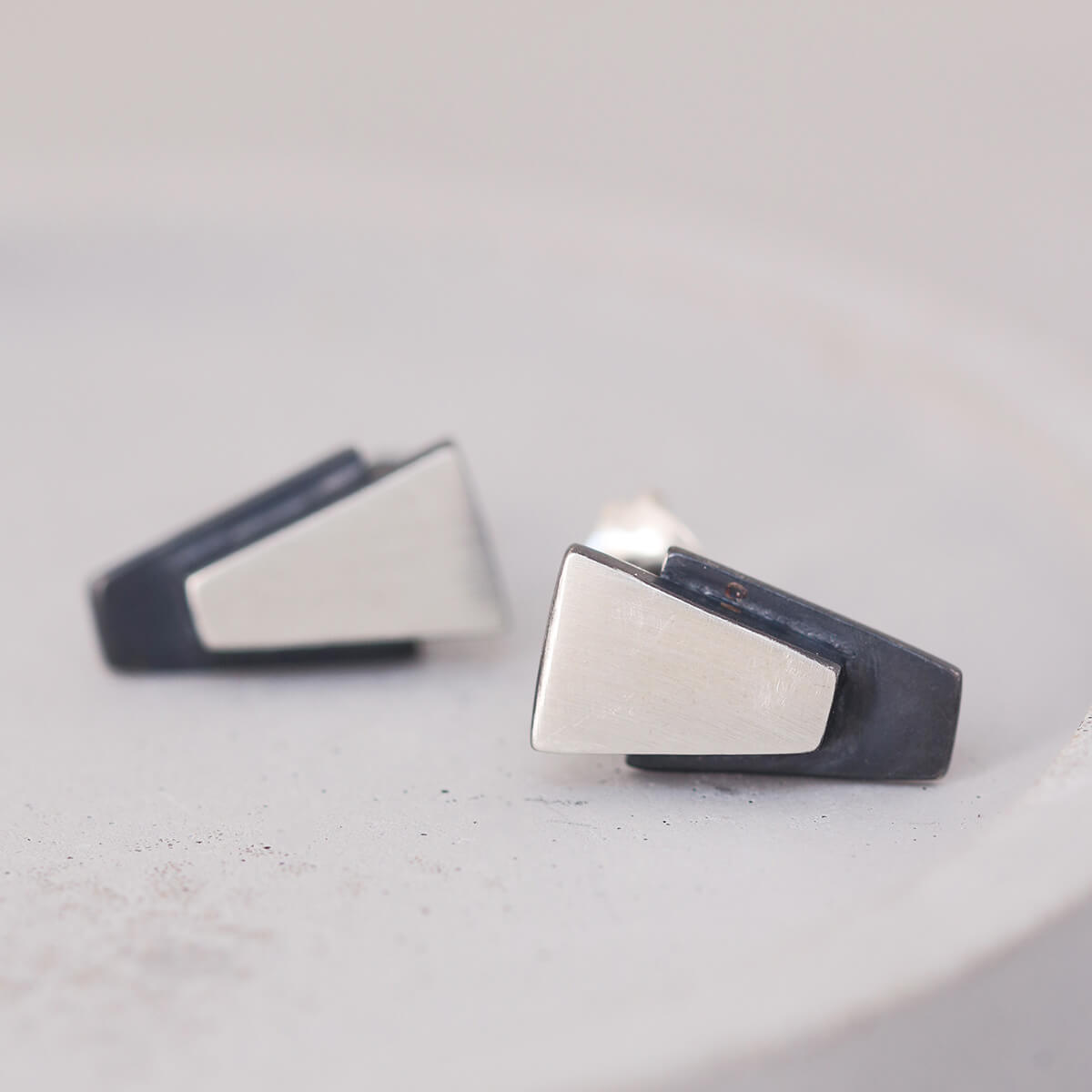 Small black stud earrings for women on grey dish, sterling silver design suitable for bridal jewellery or bridesmaid gifts.