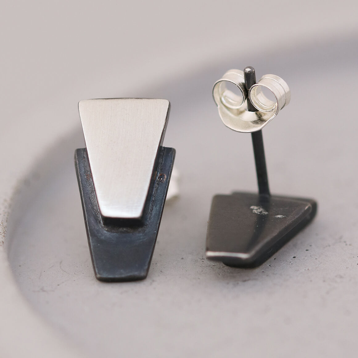 Art Deco-inspired sterling silver black earrings on grey dish, elegant choice for Christmas gifting or special occasions.