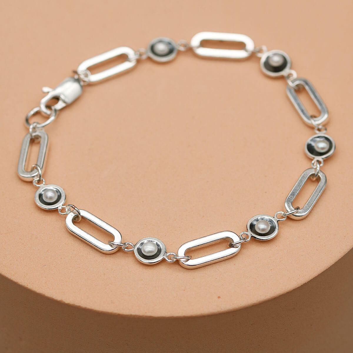 Handmade black pearl chain bracelet featuring five genuine freshwater pearls in oxidised sterling silver settings on a bold sterling silver chain.
