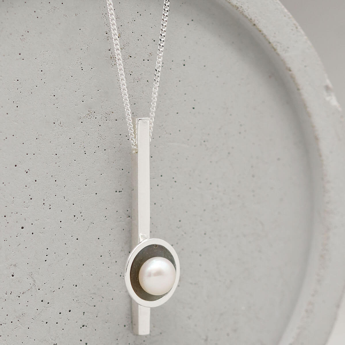 Black pearl bar necklace showcasing an oxidised sterling silver pendant with genuine freshwater pearl.