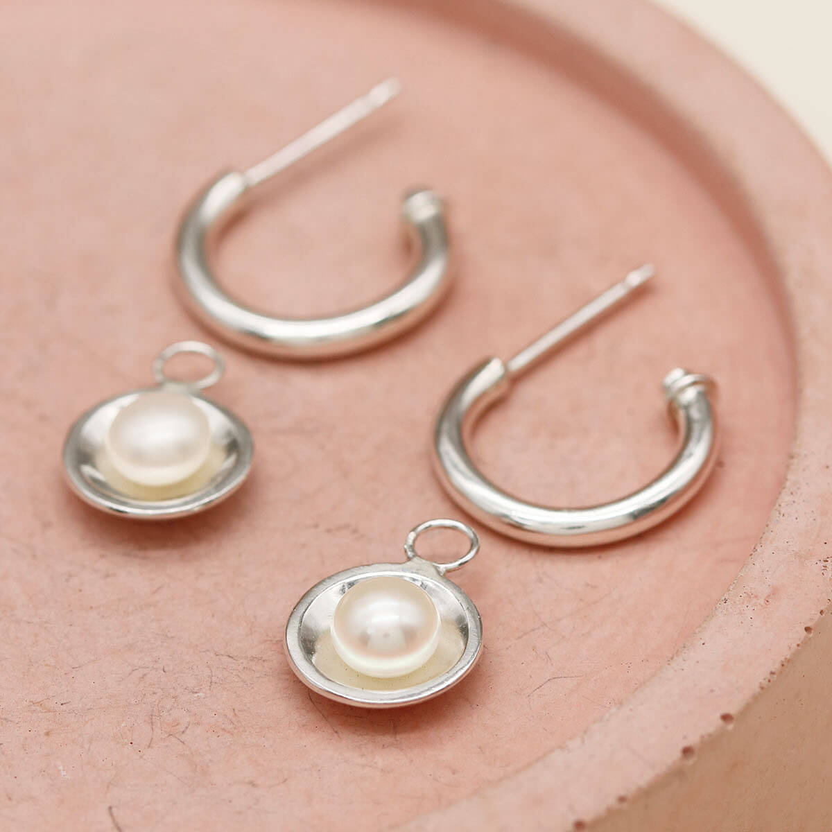 Contemporary sterling silver pearl drop hoop earrings inspired by elegant Art Deco design.