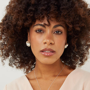 Model wearing handmade sterling silver pearl stud earrings with freshwater pearls