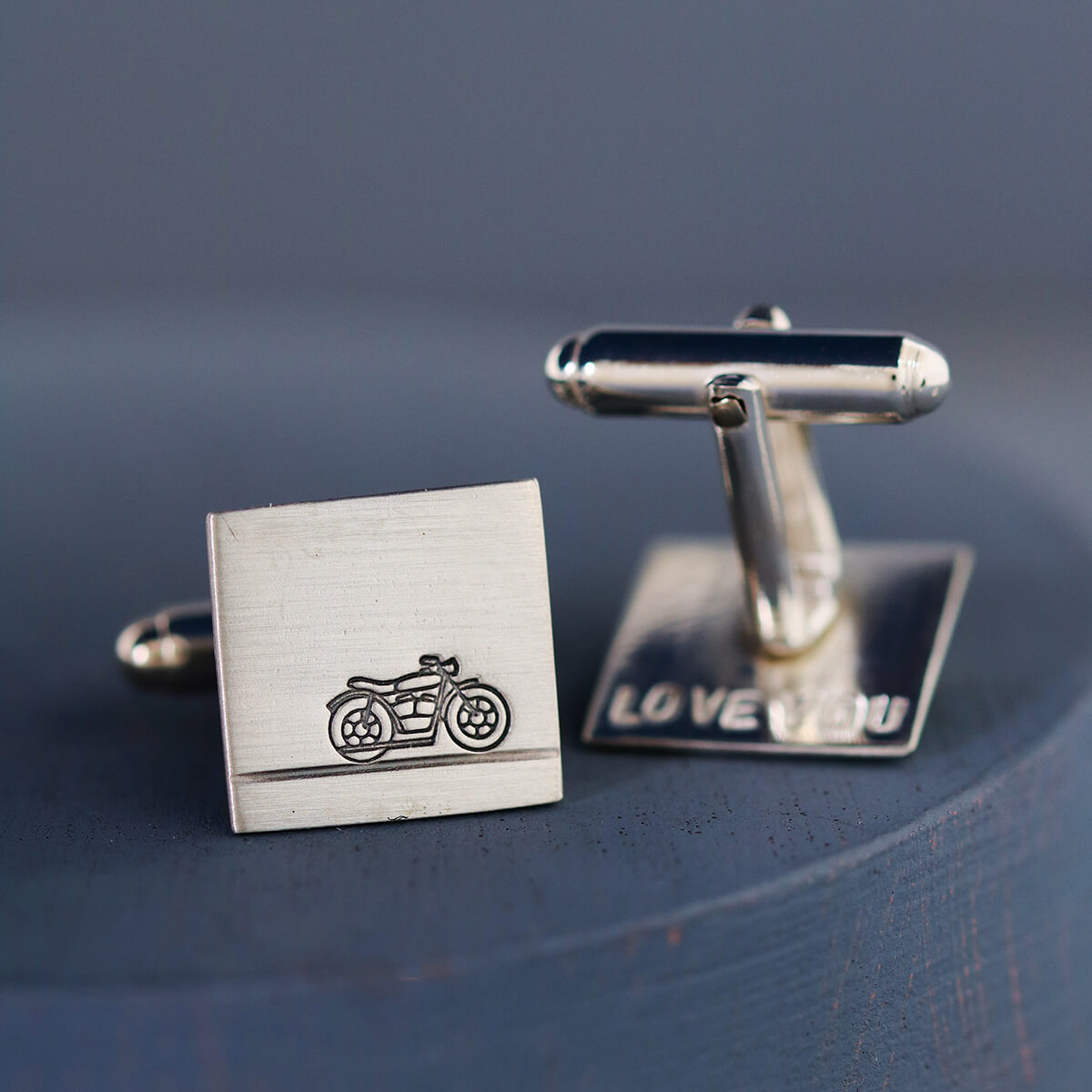 Motorbike cufflinks on a deep blue background, ideal gifts for a biker dad on his birthday or Father’s Day