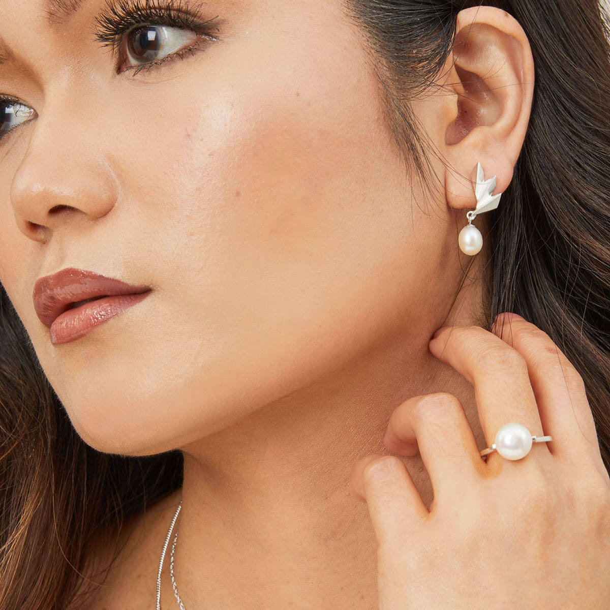 Model wearing a large freshwater pearl ring in sterling silver