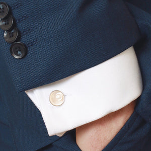 Handmade pearl cufflinks styled with formal menswear, white shirt and tailored blue suit.