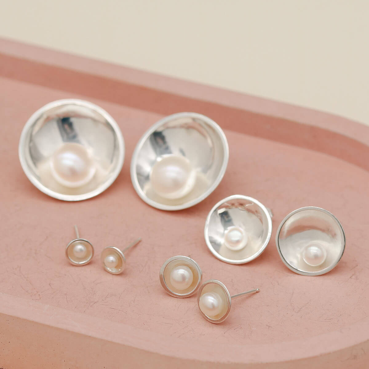 Comparison of Petite, Classic, Signature and Statement sterling silver pearl earrings showing all four sizes side by side.
