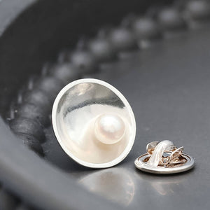 Sterling silver pearl tie pin displayed on a dark grey background, designed for weddings, anniversaries and formal occasions.