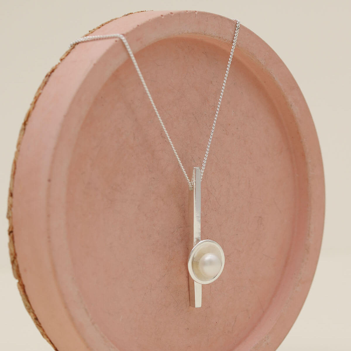 Elegant sterling silver pearl bar necklace showcasing a polished silver bar and 5mm freshwater pearl.